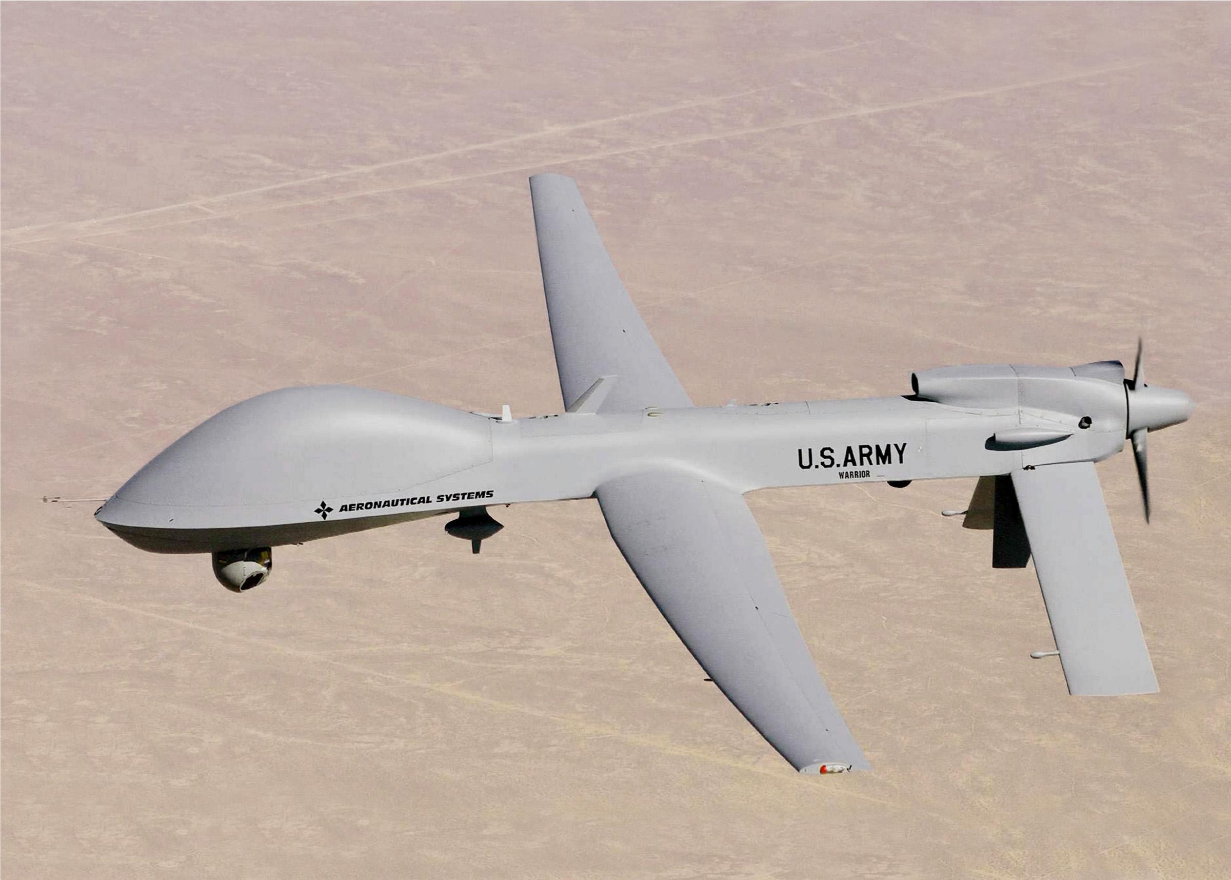 U.S. Army MQ-1C Gray Eagle unmanned aircraft in flight over desert terrain